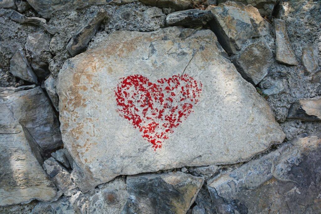 A heart drawn with a red crayon on a rock